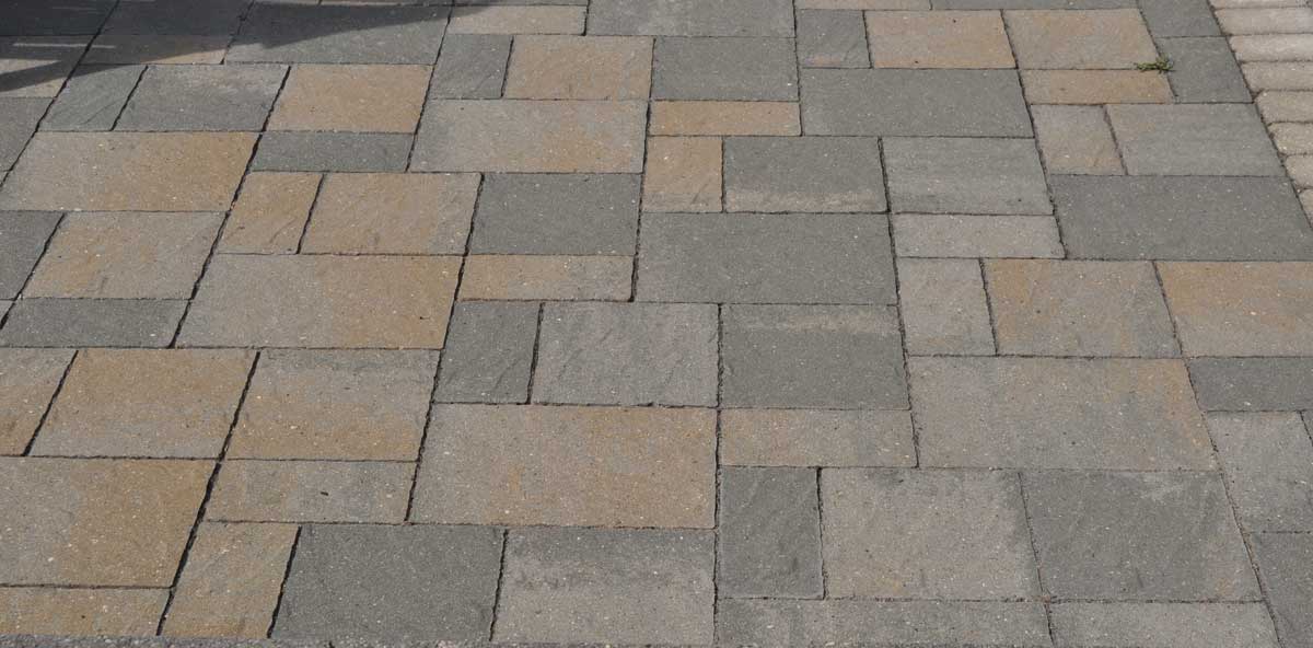 paver patio with a pattern using small and large pavers with various colors and textures