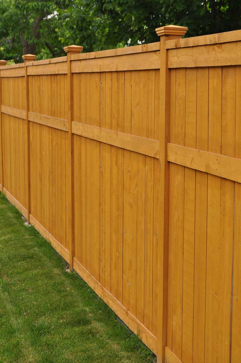 New modern wood privacy fence with a fresh stain finish