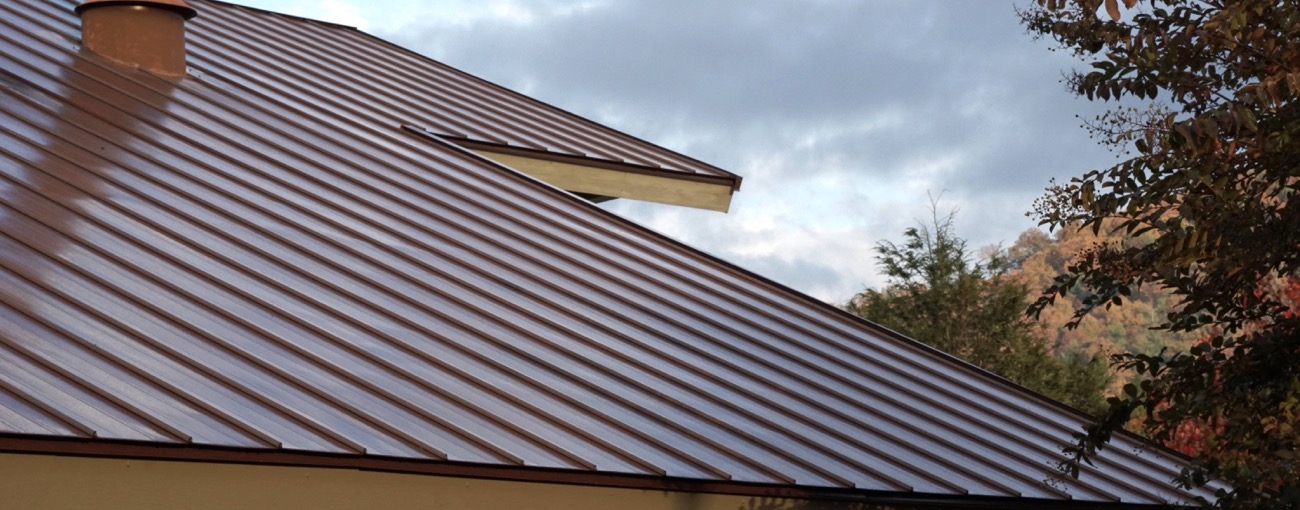 Home with a metal roof. Metal roofs are beautiful, very durable, and last a long time.