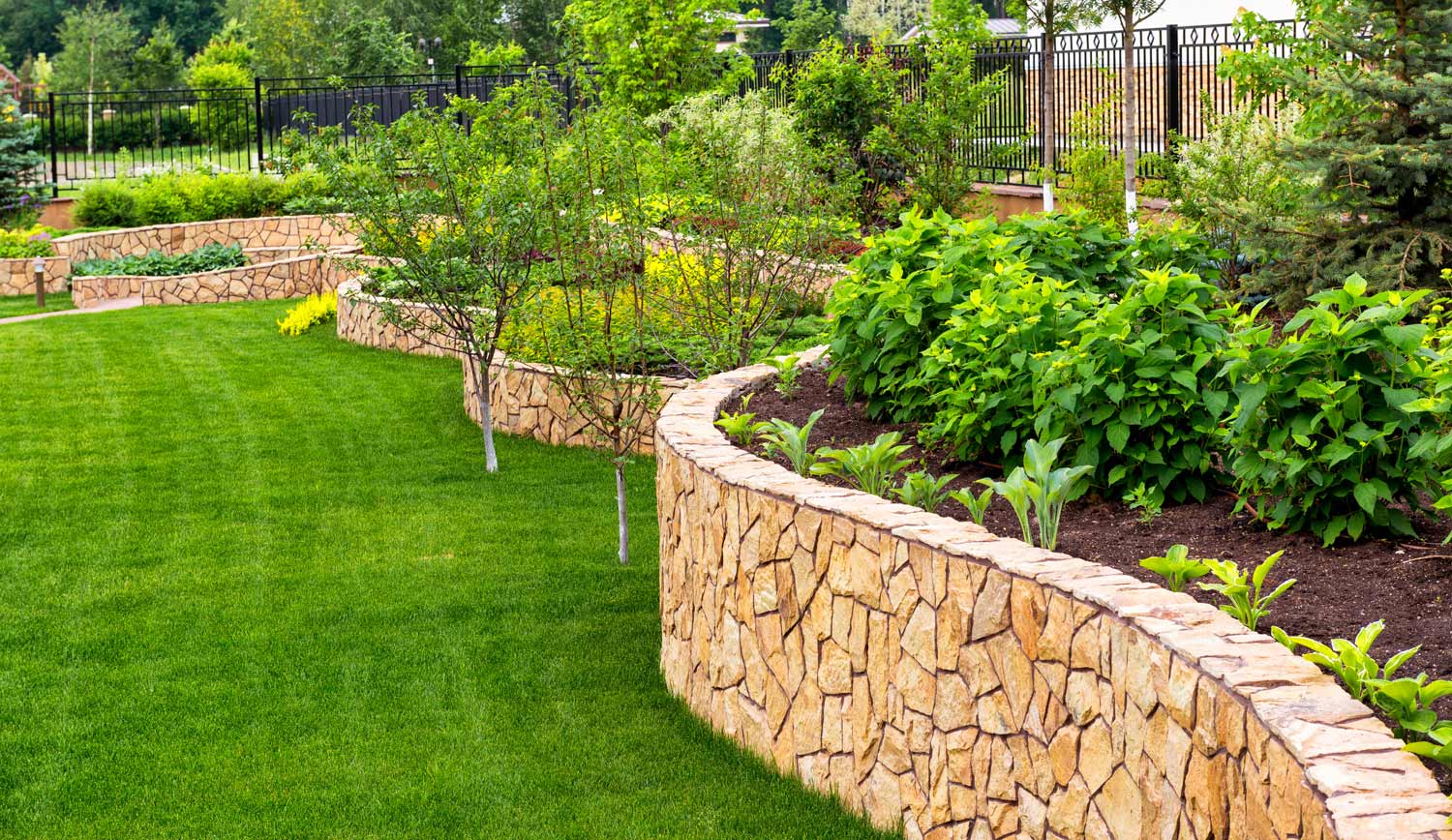 Beautifully manicured landscaping and retaining wall